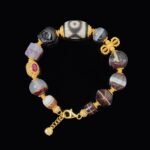 Dzi Bead & Skull Guardian Bracelet with Ruby Gold Accents – Protection, Wisdom & Sacred Power