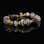 Dzi Bead & Skull Guardian Bracelet with Ruby Gold Accents – Protection, Wisdom & Sacred Power