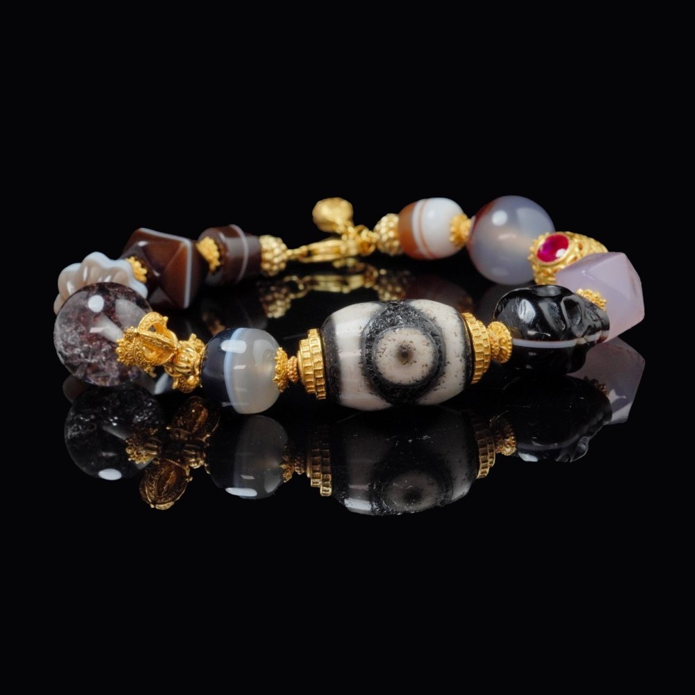 Dzi Bead & Skull Guardian Bracelet with Ruby Gold Accents – Protection, Wisdom & Sacred Power