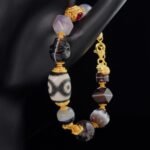 Dzi Bead & Skull Guardian Bracelet with Ruby Gold Accents – Protection, Wisdom & Sacred Power