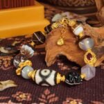 Dzi Bead & Skull Guardian Bracelet with Ruby Gold Accents – Protection, Wisdom & Sacred Power